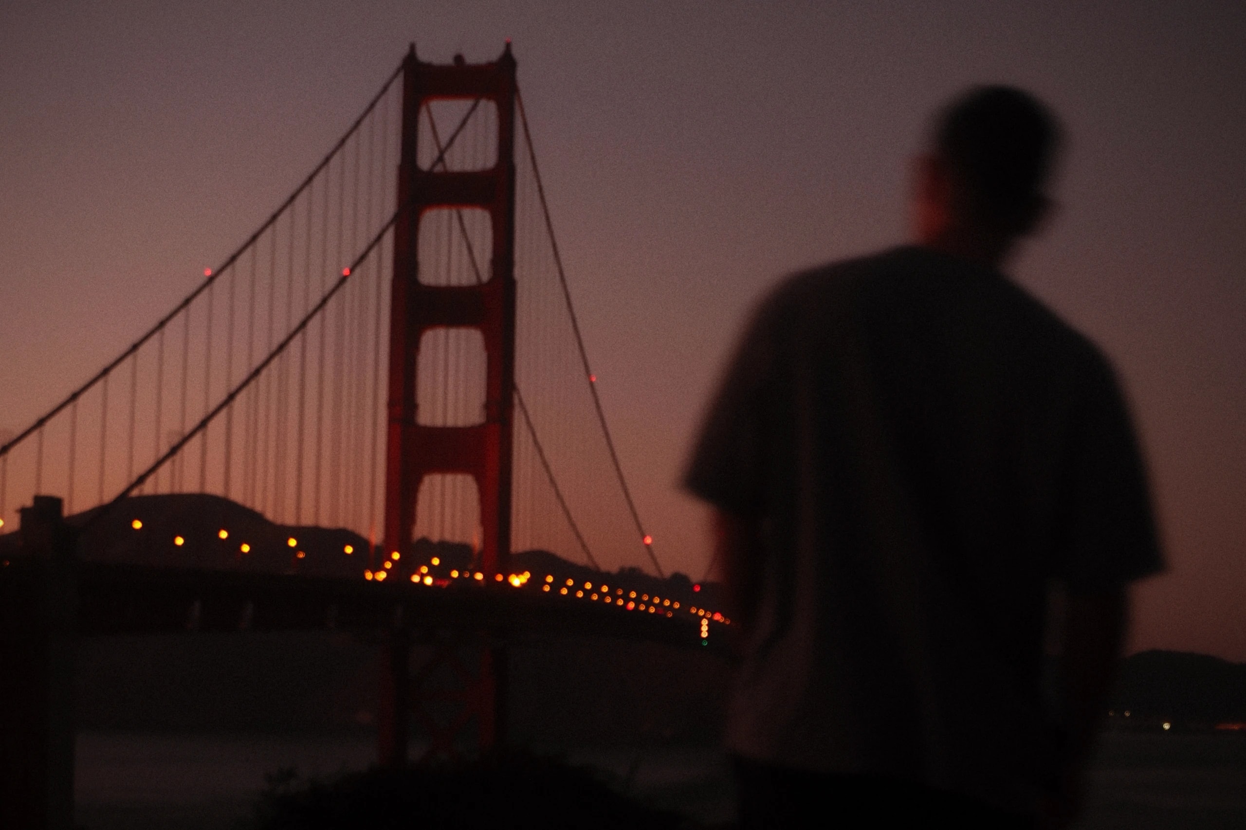 Rafael standing close to the Golden Gate Bridge at night