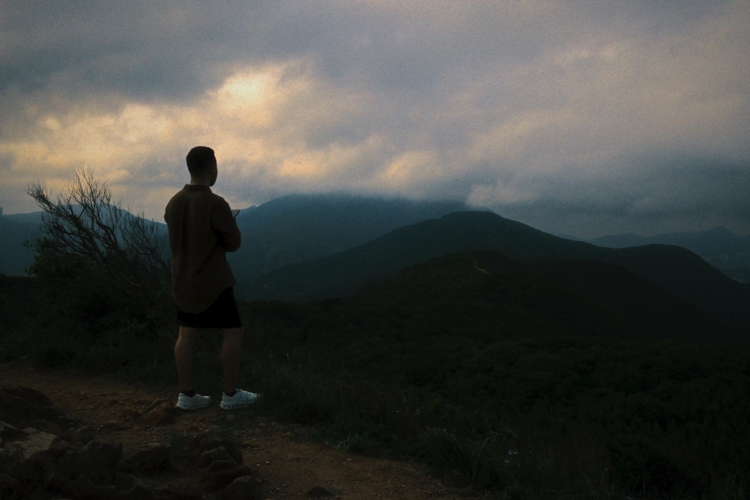 Rafael looking across a mountain range in Hong Kong