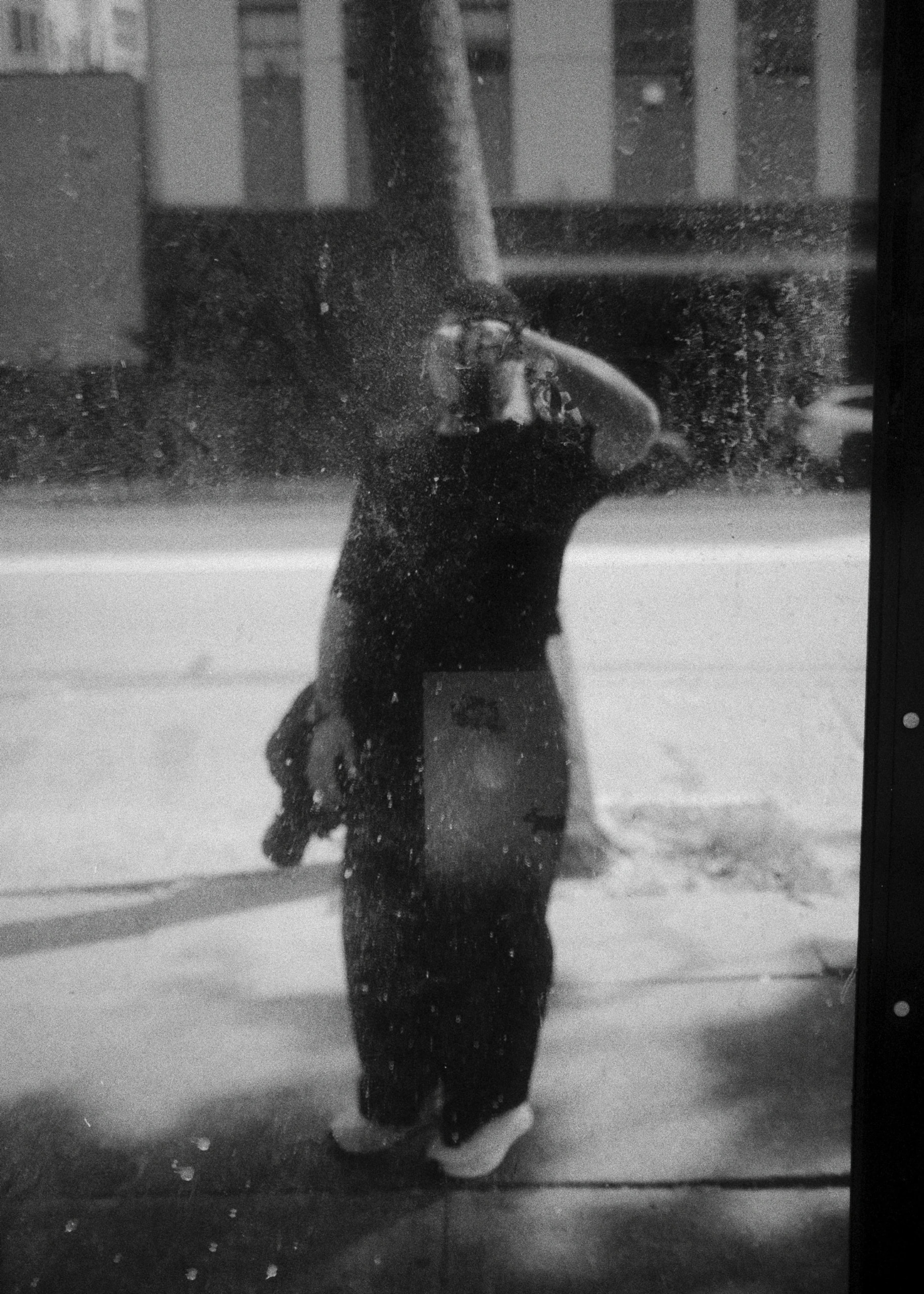 Rafael photographing his reflection in a mirrored wall in San Francisco, in black and white